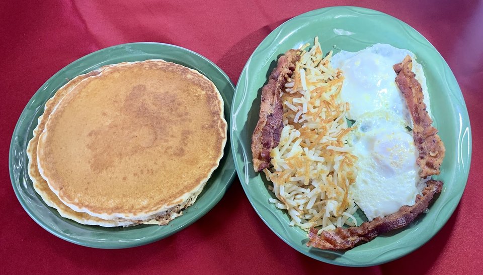 Breakfast plates on a casual family restaurant table.